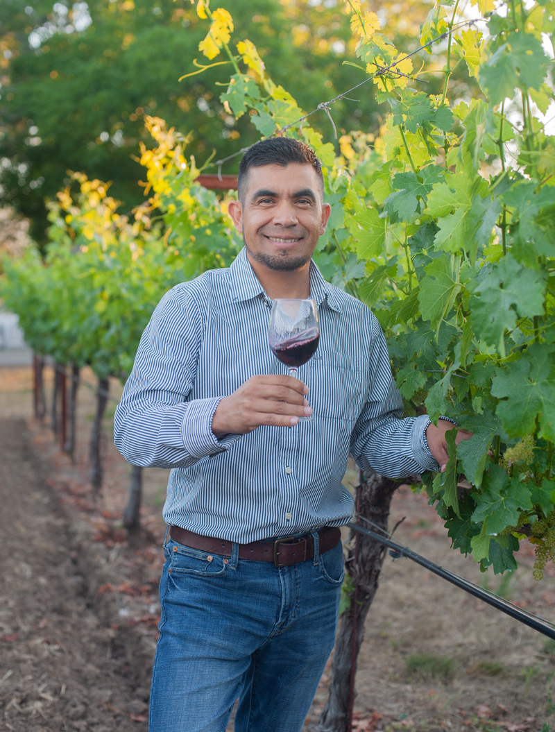 cesar in vineyard with wine glass